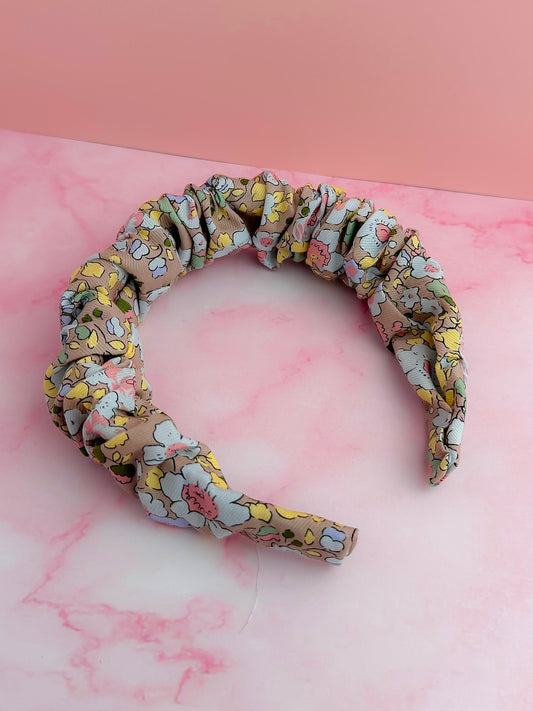 Floral patterned headband on a pink marble background